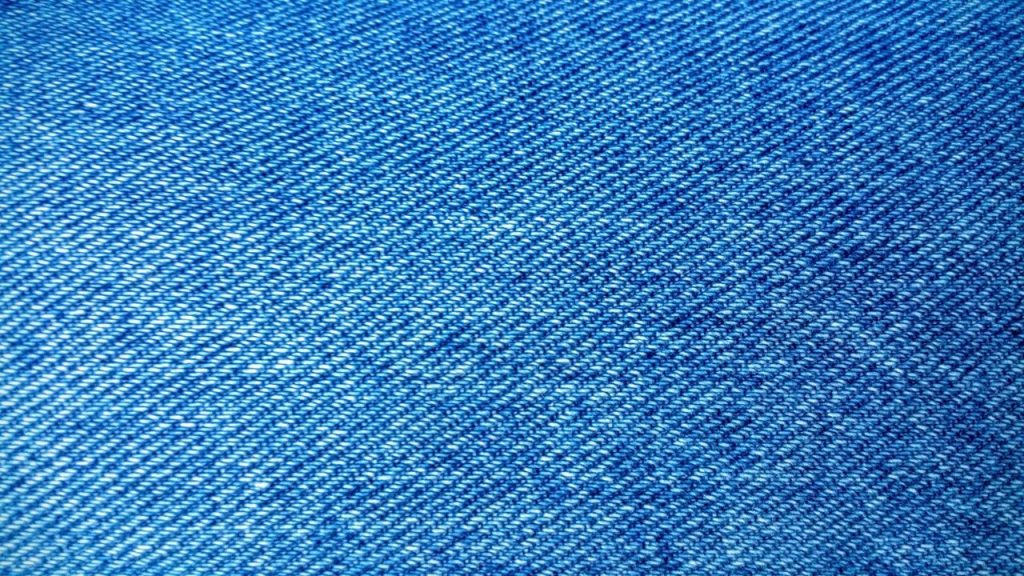 Detailed close-up of blue denim fabric showcasing texture and weave pattern.
